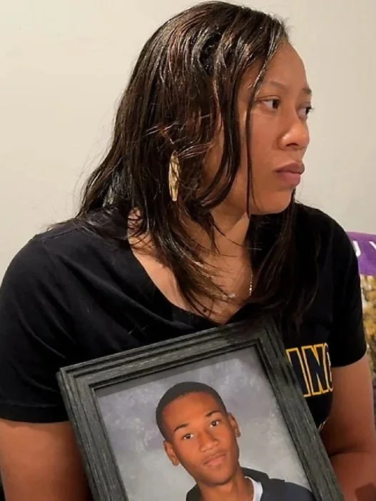 Picture of Tamia Woods holding a photo of her son, James