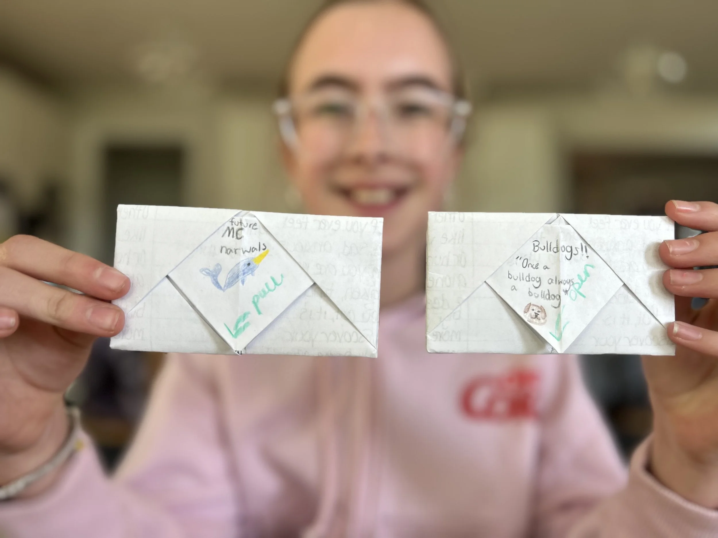 Volunteer for Rhy's Above holding hand folded notes of inspiration and encouragement.