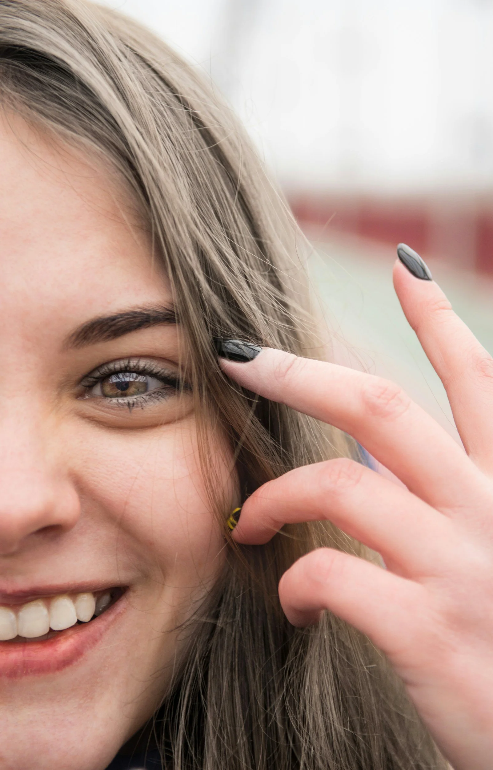 Soft focus image of hands and face, expressing emotional regulation, self-regulation through sensation, and supportive co-regulation in relational therapy.