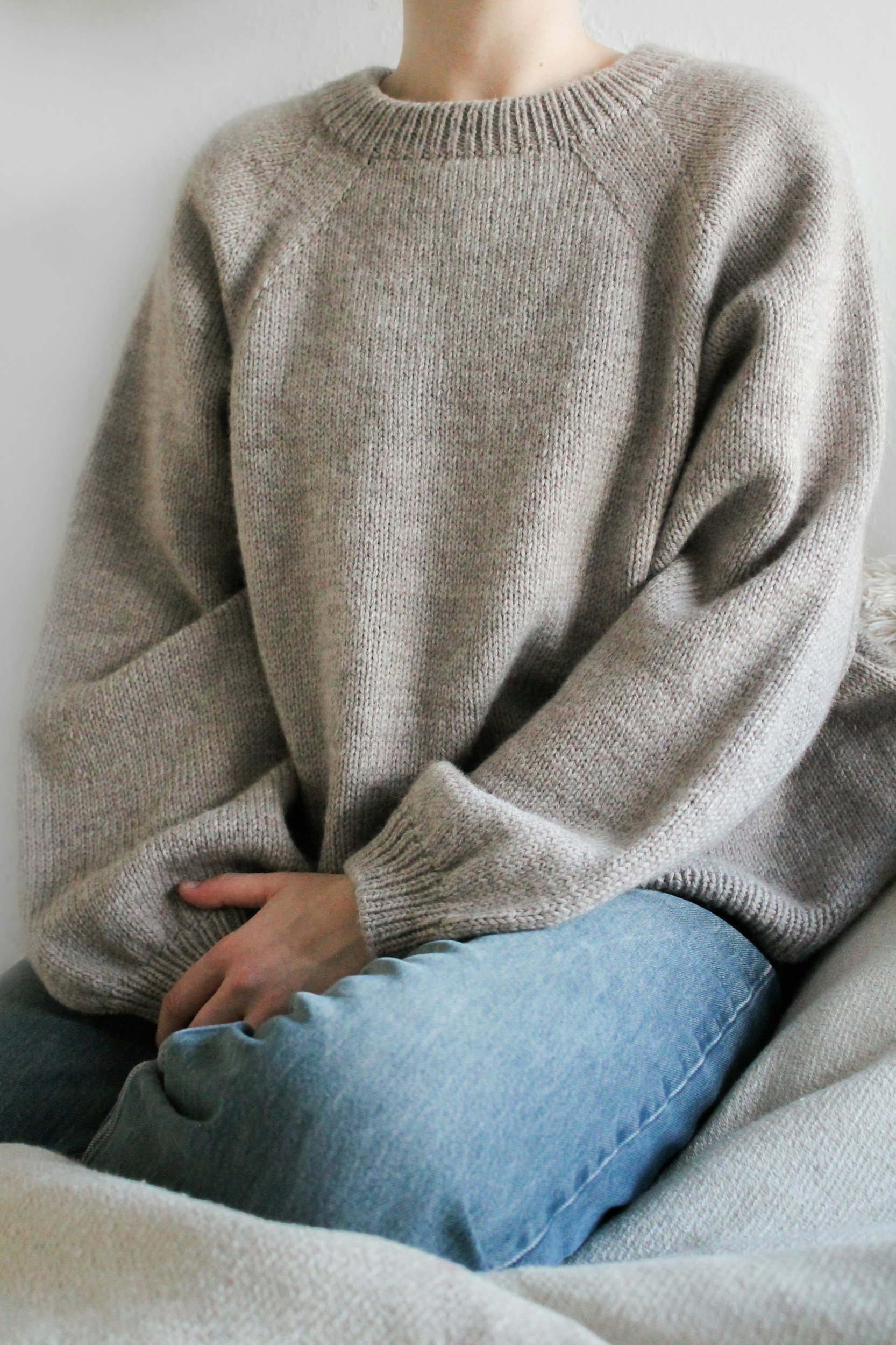 A person resting on a sofa with a blanket around their shoulders, representing overwhelm, emotional sensitivity, and the need for gentle therapeutic support.