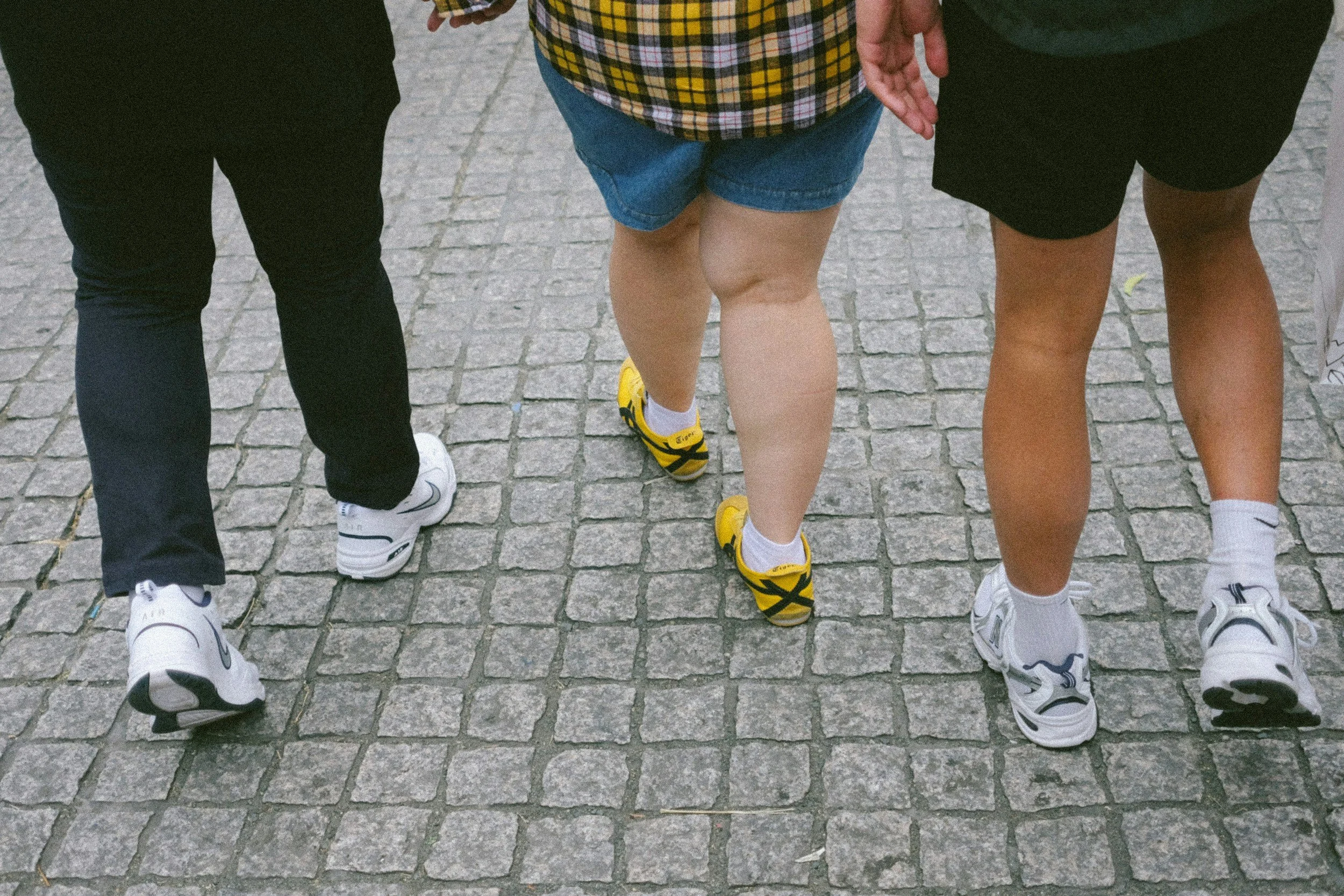 Three pairs of legs walking side by side, showing how simple movement or changing your body position from sitting to standing can shift your perspective as we explore movement in therapy.