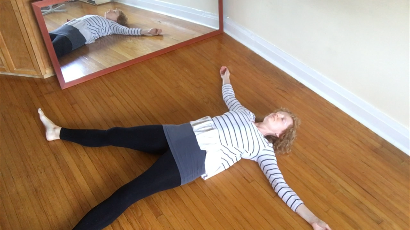An image of Alison Taylor lying prone, arms and legs outstretched, expressing emotional regulation, self-regulation through sensation, and supportive co-regulation in relational therapy.