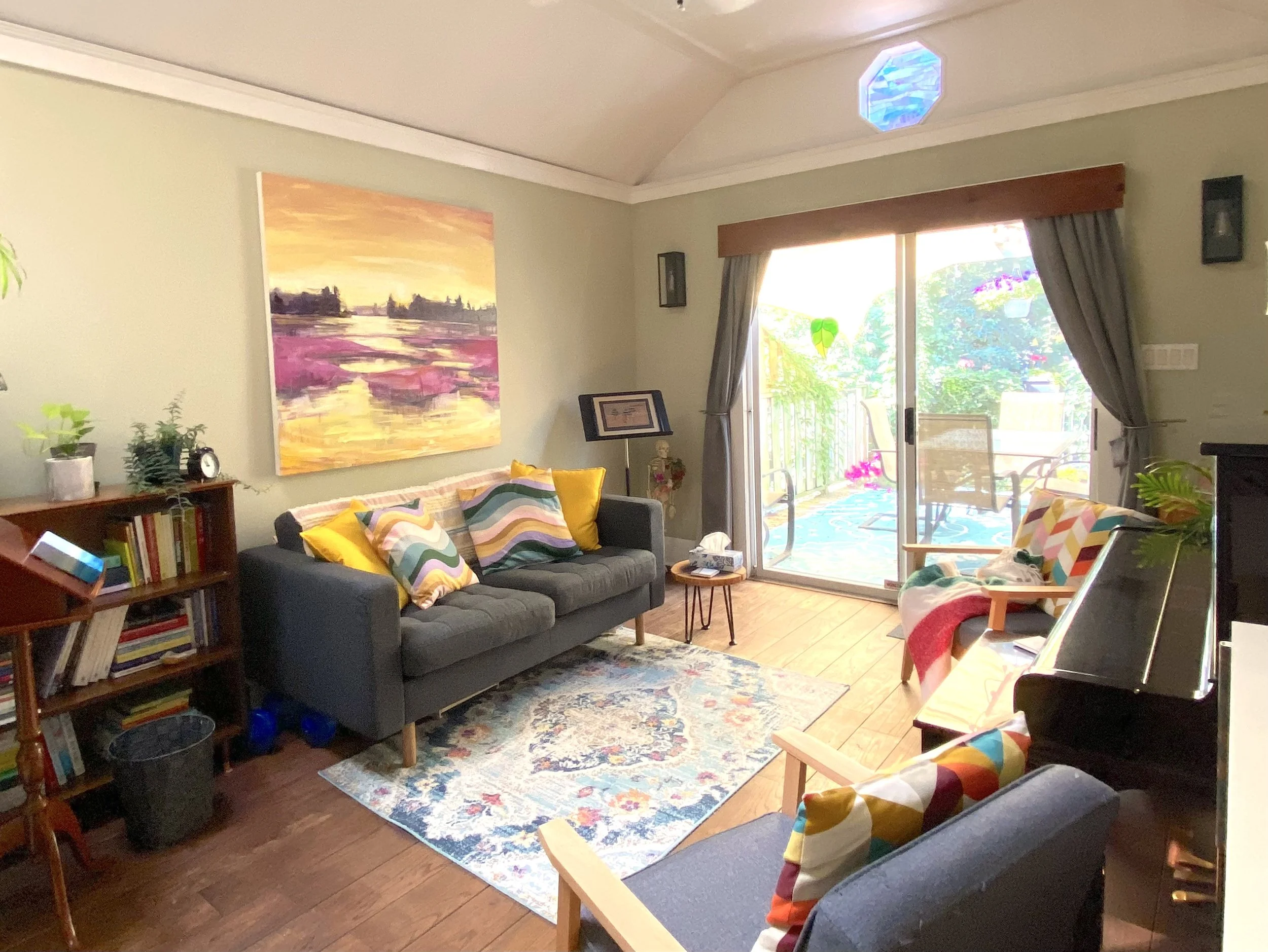 Two chairs in a softly lit therapy room, symbolizing relational safety, co-regulation, and covid-conscious Gestalt therapy.