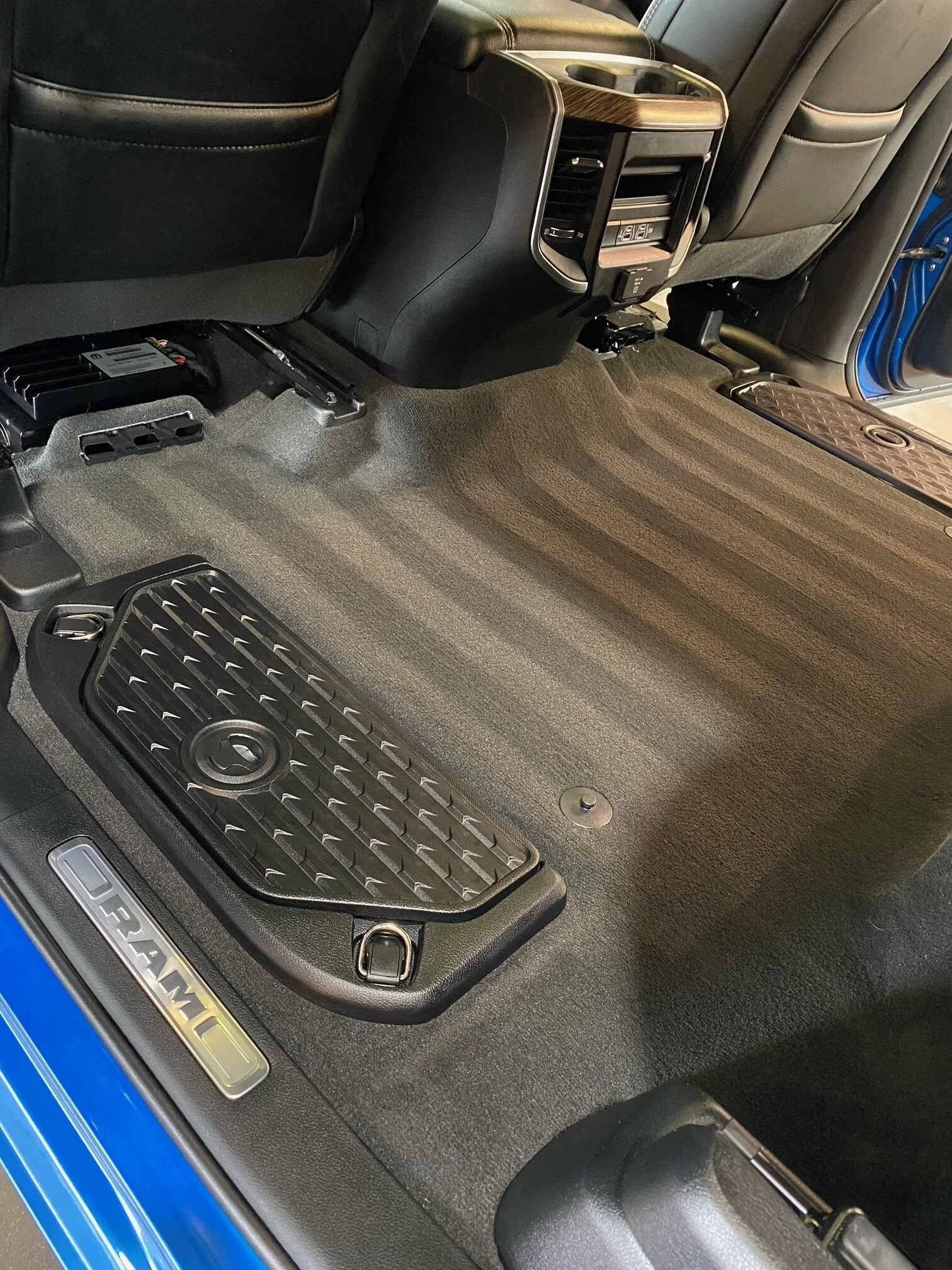 A clean vehicle floor area featuring a protected all-weather floor mat over freshly groomed carpet with professional vacuum lines in NKY.