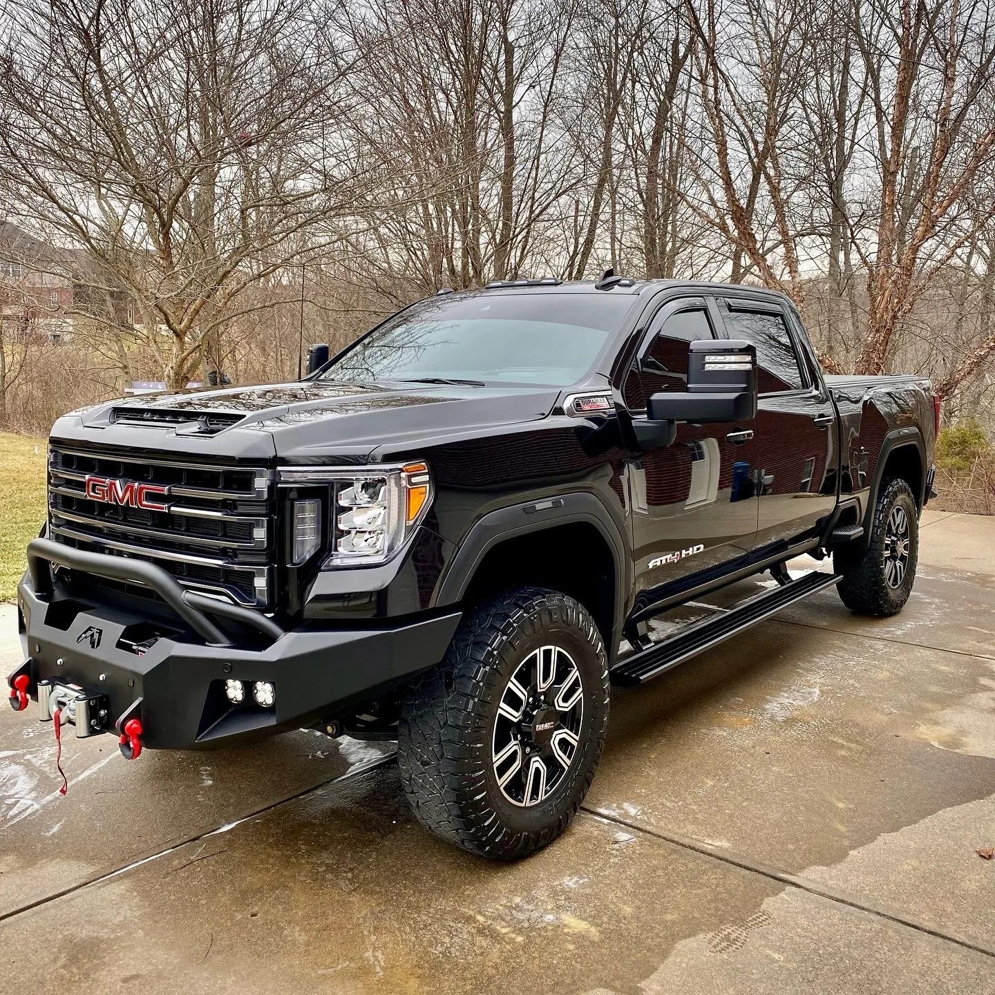 A black GMC Sierra pickup truck with a mirror-like reflective finish and deep paint clarity following a professional machine polish and paint enhancement service in Northern Kentucky.