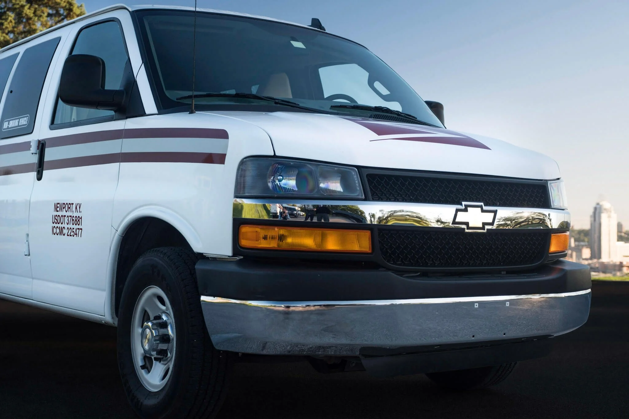 A white Chevrolet Express commercial van with red accents, representing the mobile fleet detailing and maintenance services provided to business partners throughout Greater Cincinnati.