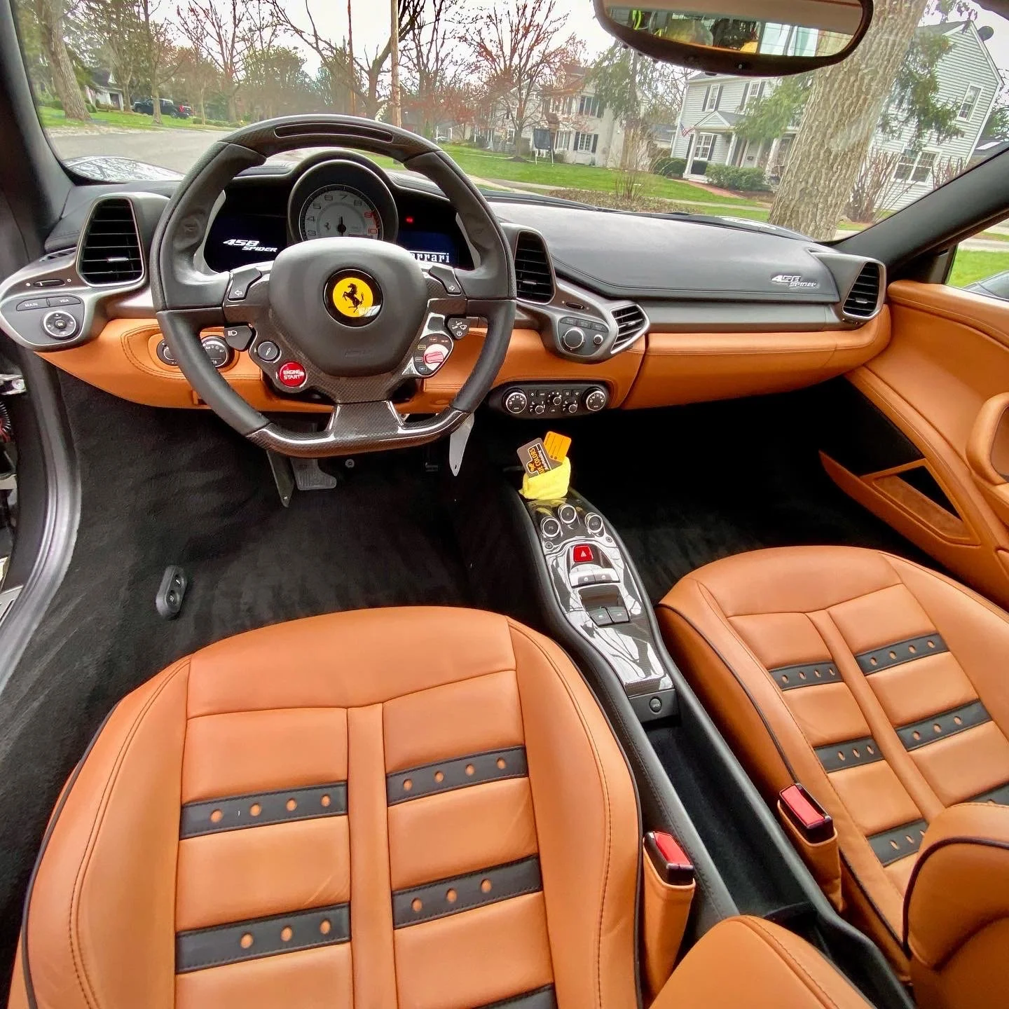 Close-up of tan leather luxury car seats with black accents, meticulously cleaned and conditioned to a factory-fresh appearance for a Cincinnati client.