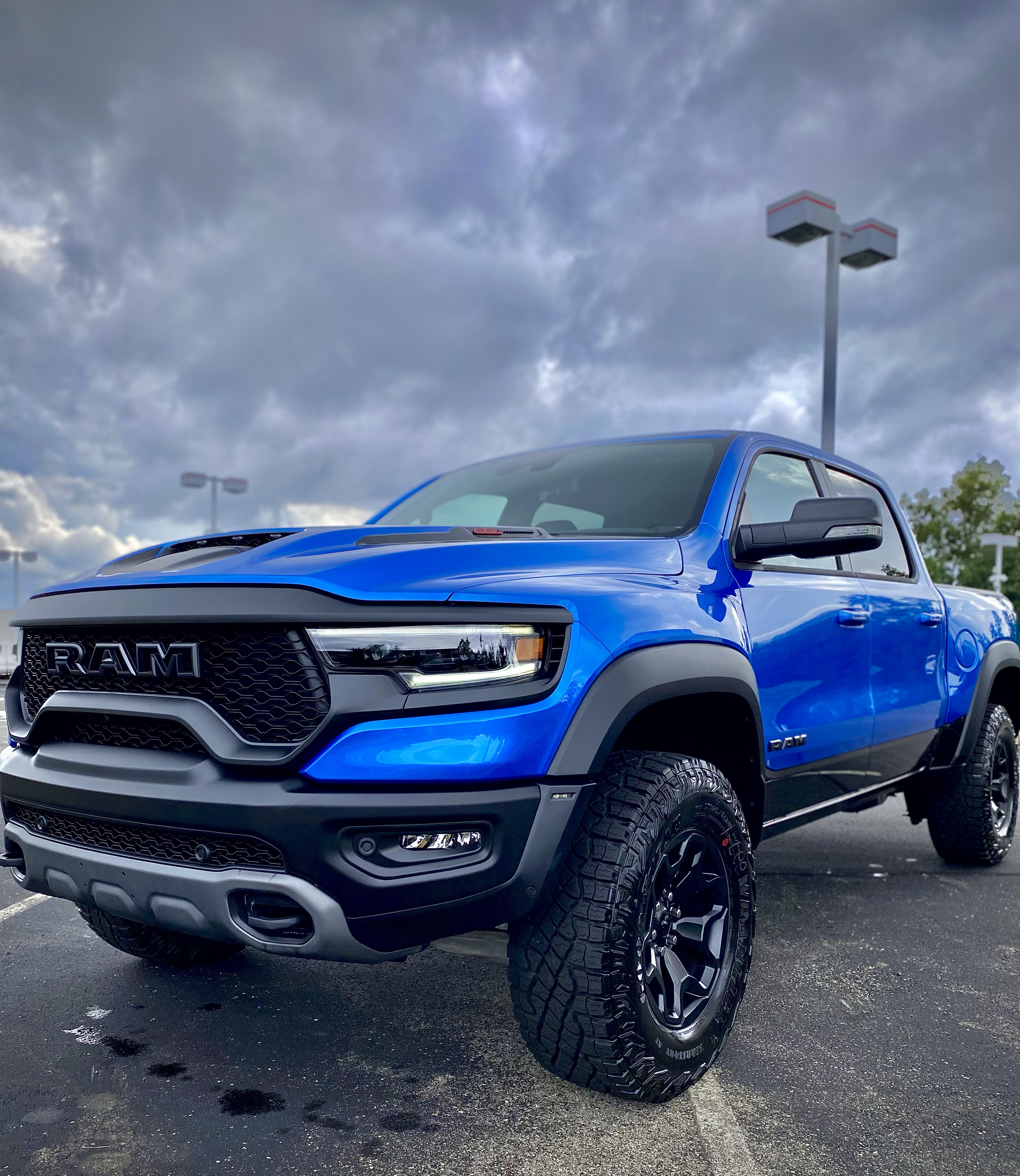 A blue Ram TRX truck with off-road tires and a high-gloss finish, showcasing a vehicle built to brave the elements after a professional exterior detailing service in Cincinnati.