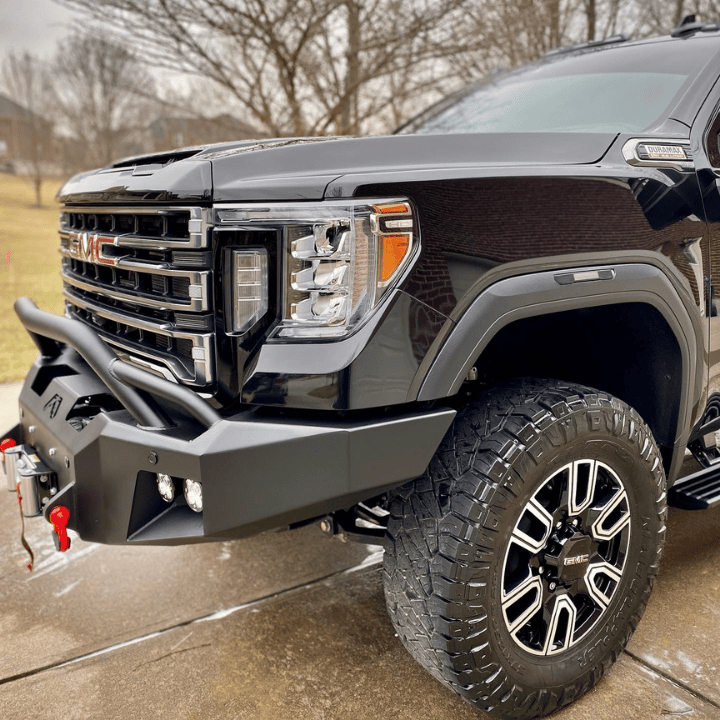 A professional front-end view of a black GMC Sierra truck in Northern Kentucky, showcasing crystal-clear headlight lenses and a rugged, polished heavy-duty bumper.