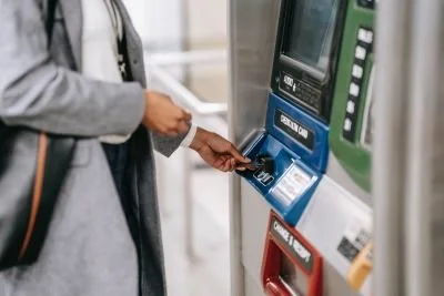 woman withdrawing emergency funds from atm