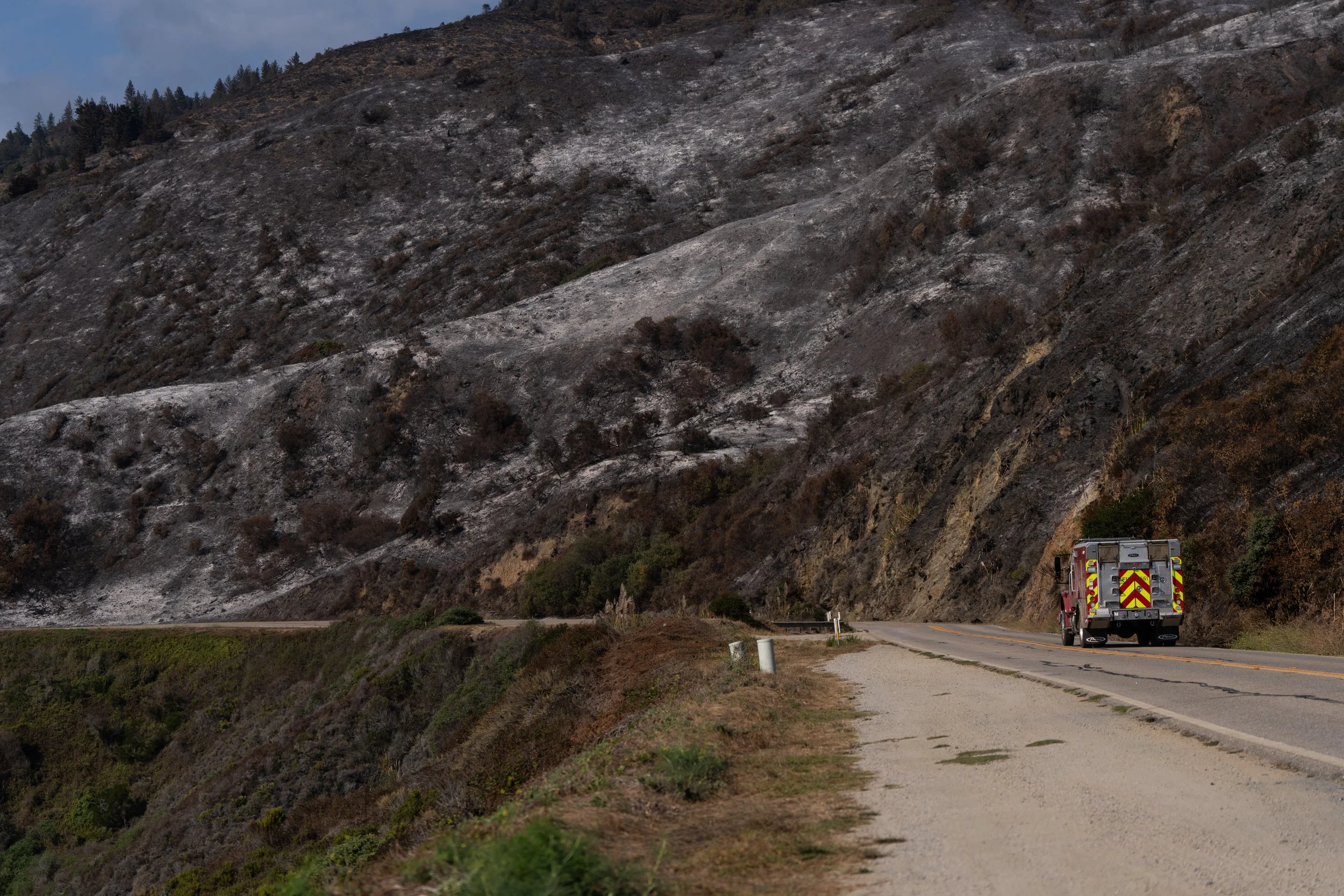 A fire engine passes vegetation burned by the Plaskett Fire along Highway 1 near Plaskett in Big Sur, Calif., Friday, Sept. 4, 2026