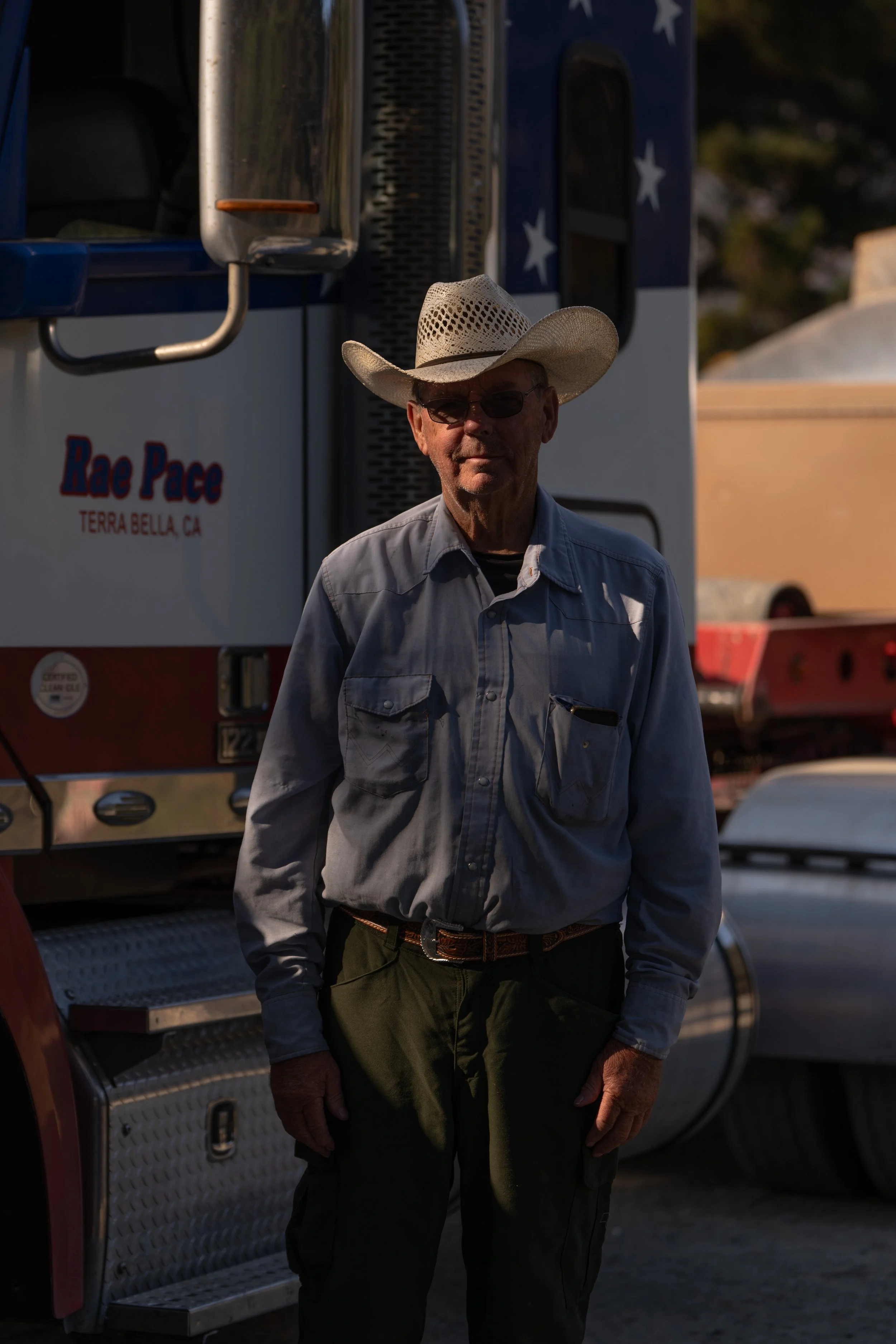 Contractor Rae Pace, whose company is providing heavy equipment for the Plaskett Fire response, poses beside his transport truck at the Plaskett Fire base camp in Big Sur, Calif., Friday, Sept. 4, 2026.