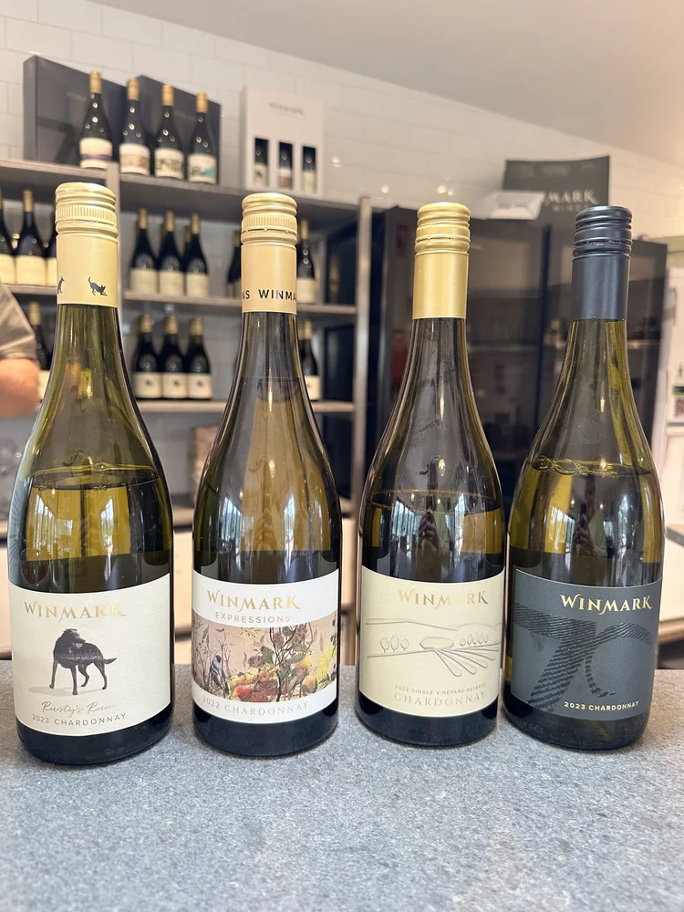 Four bottles of Winmark Chardonnay arranged for tasting