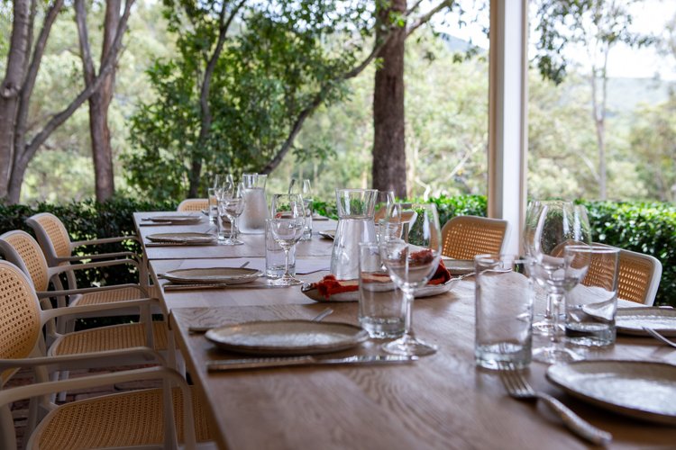 An outdoor table set for a food and wine pairing experience
