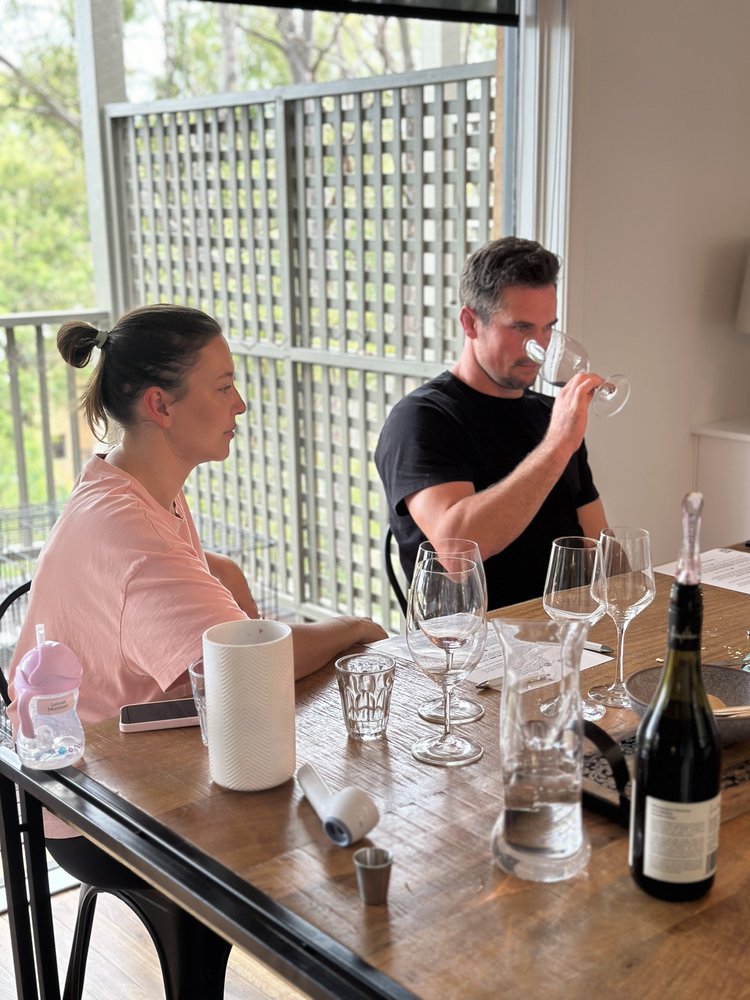 Two guests tasting wine together at Cypress Lakes