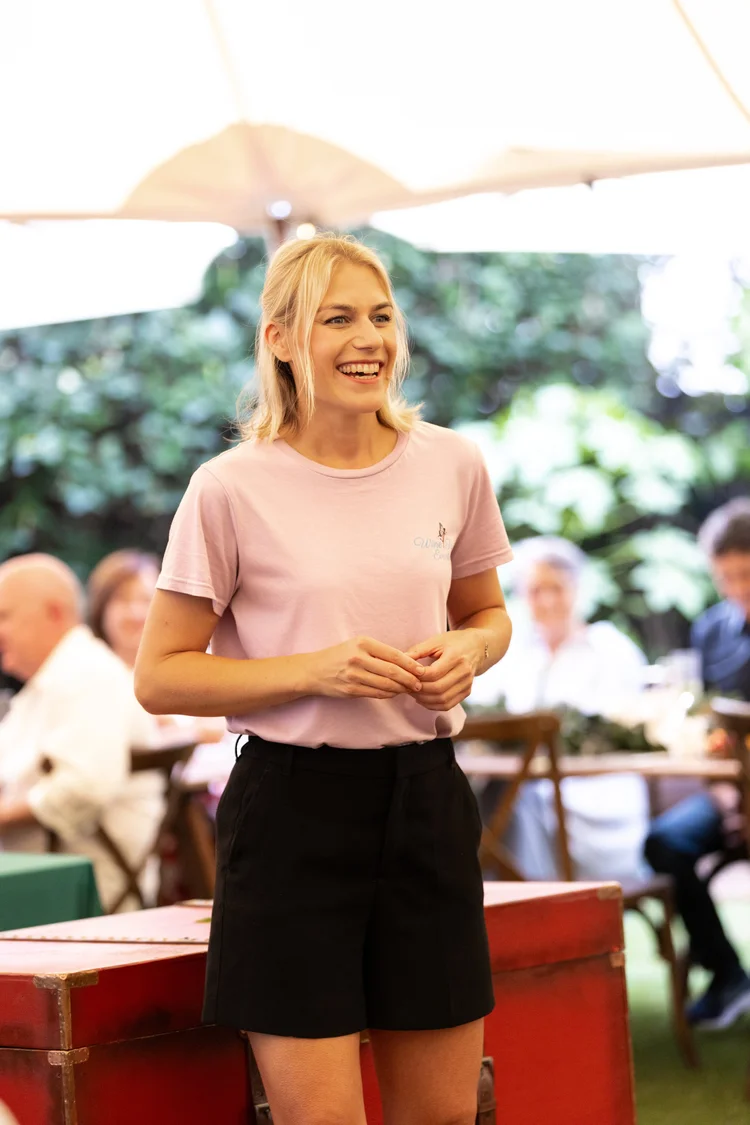 Kat speaking to guests at a wine tasting in Camden