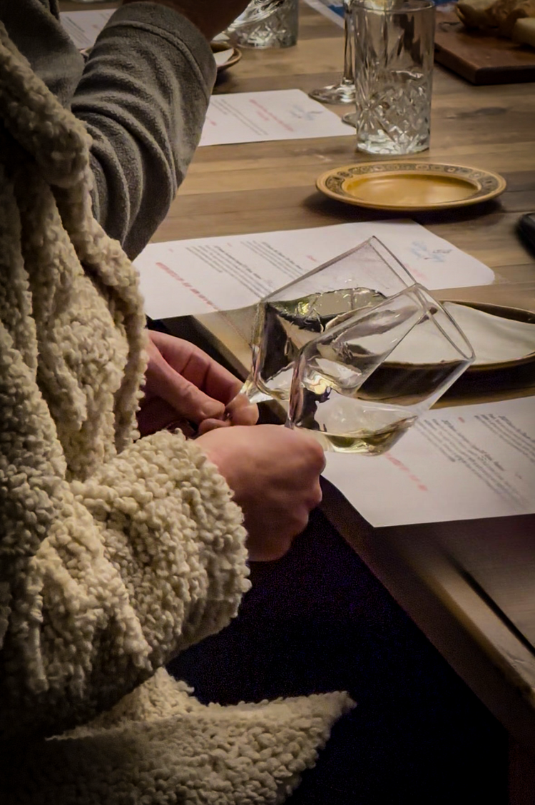 A guest comparing wines using tasting notes