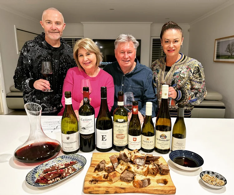 Guests gathered around a table with wines and a cheese platter in the Hunter Valley