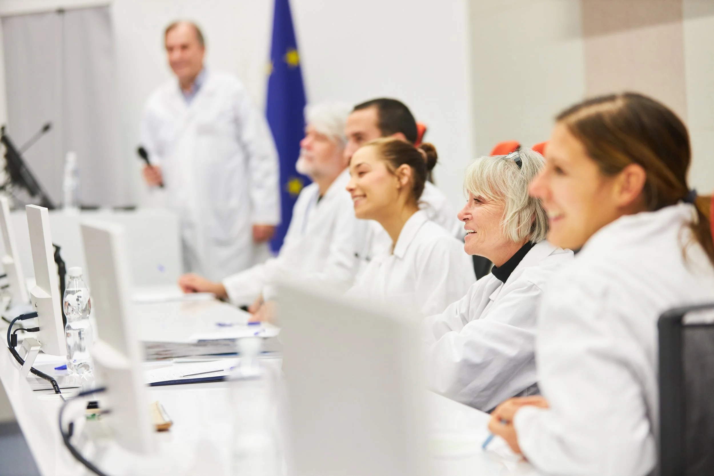 Black and white photo of a person's hands touching a round mirror