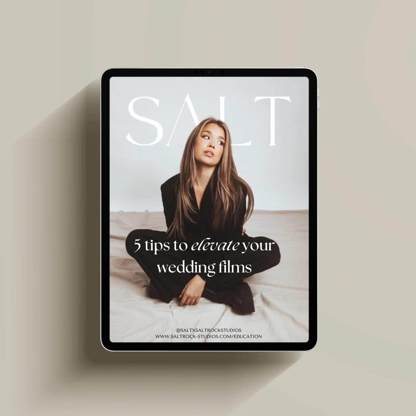 An electronic device displaying a cover image for an article titled '5 tips to elevate your wedding films' featuring a young woman with long hair sitting cross-legged.