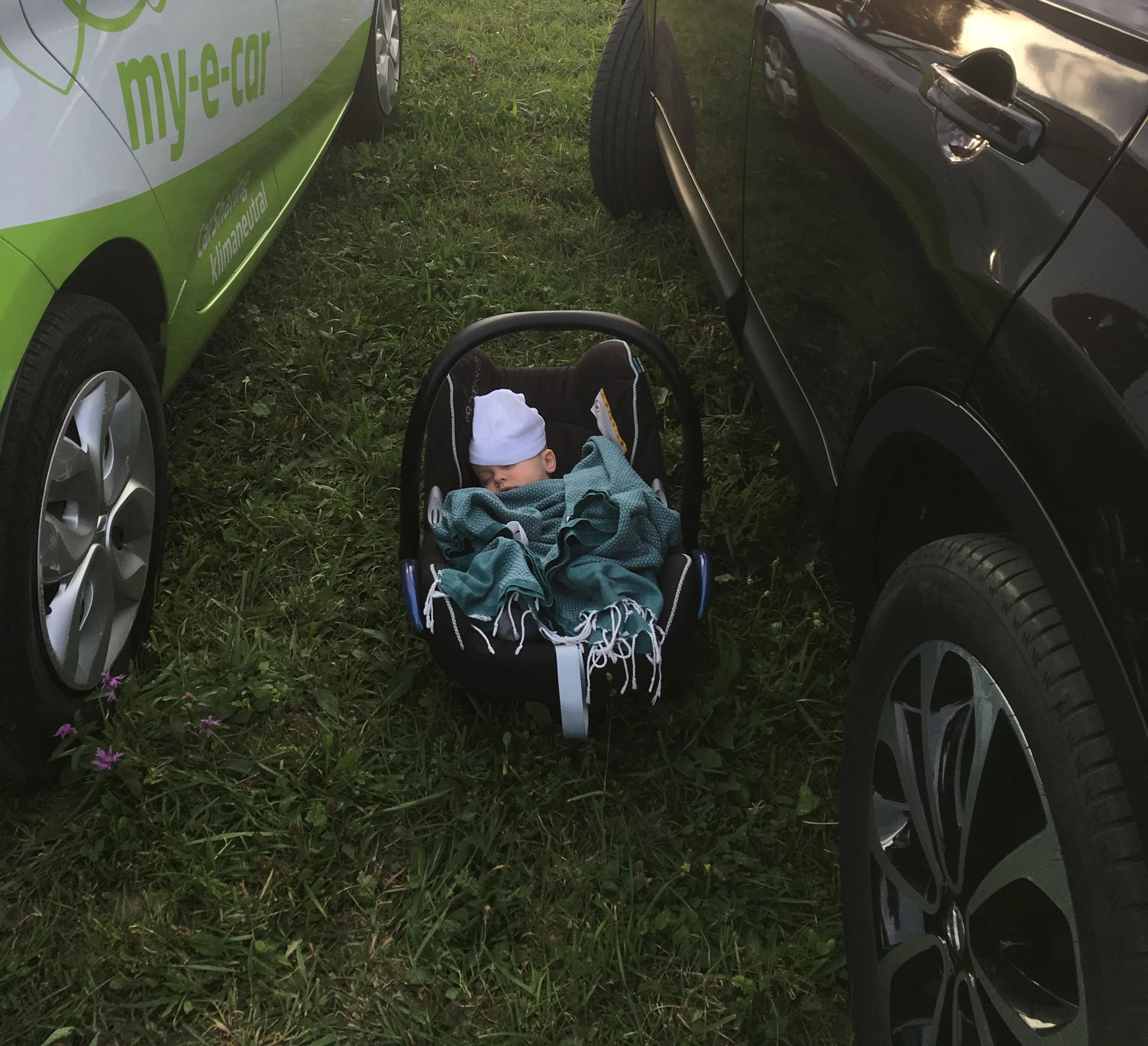 Baby in carrier on parking lot