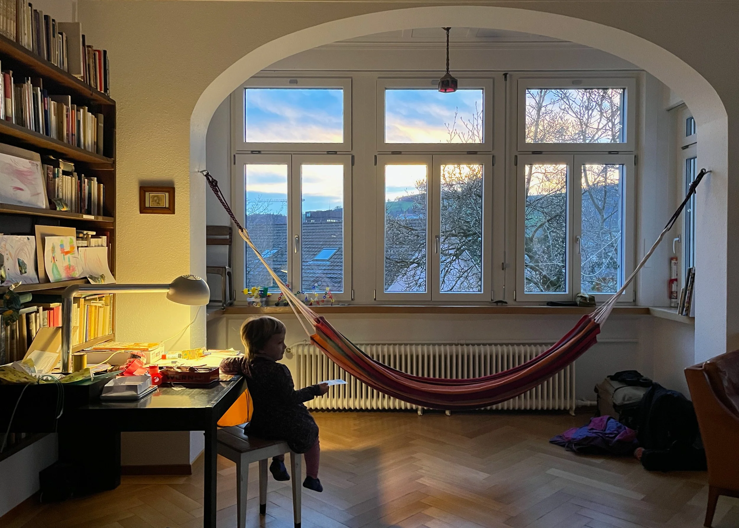 A toddler in her living room in evening light