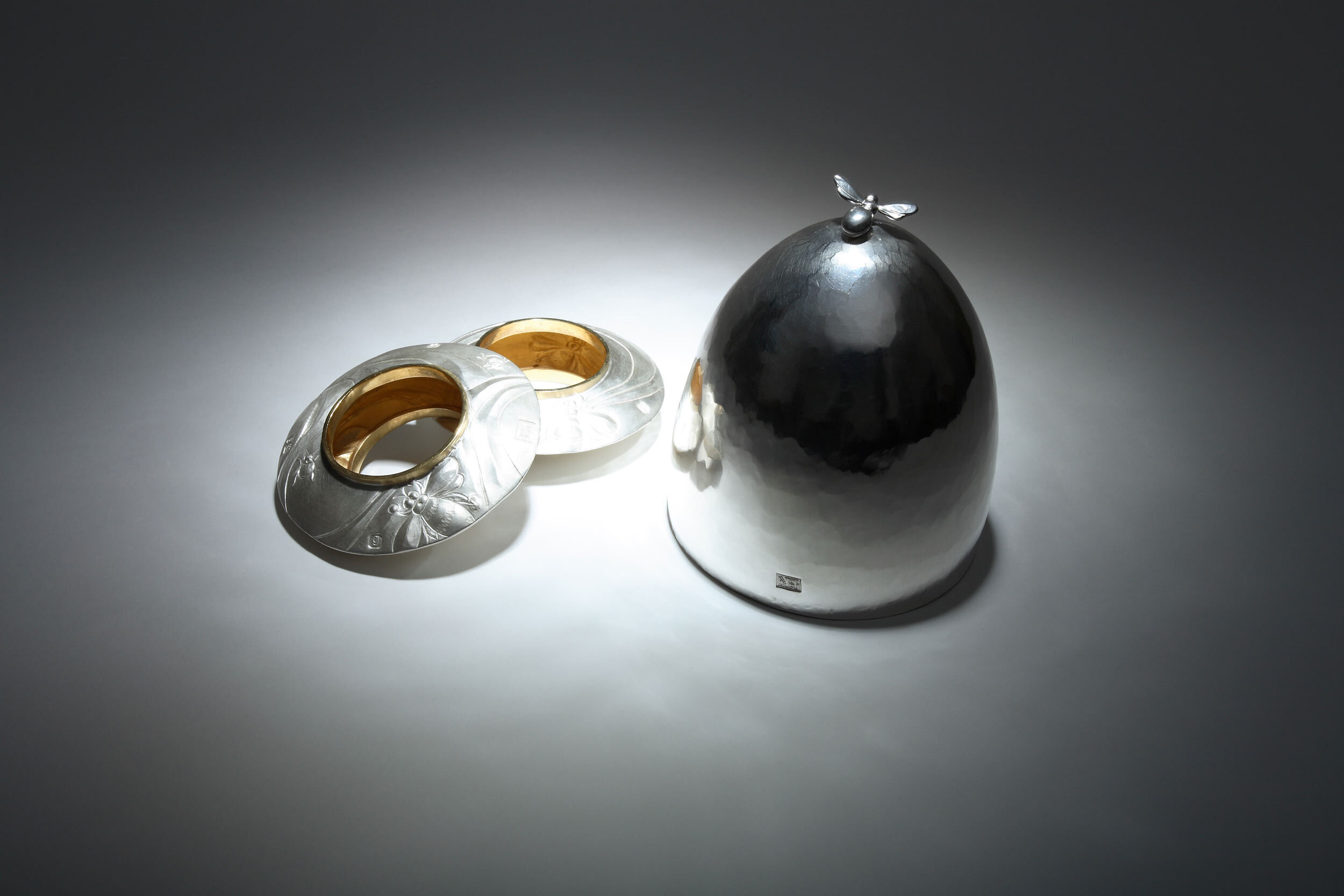Bee Napkin rings and silver beaker upturned