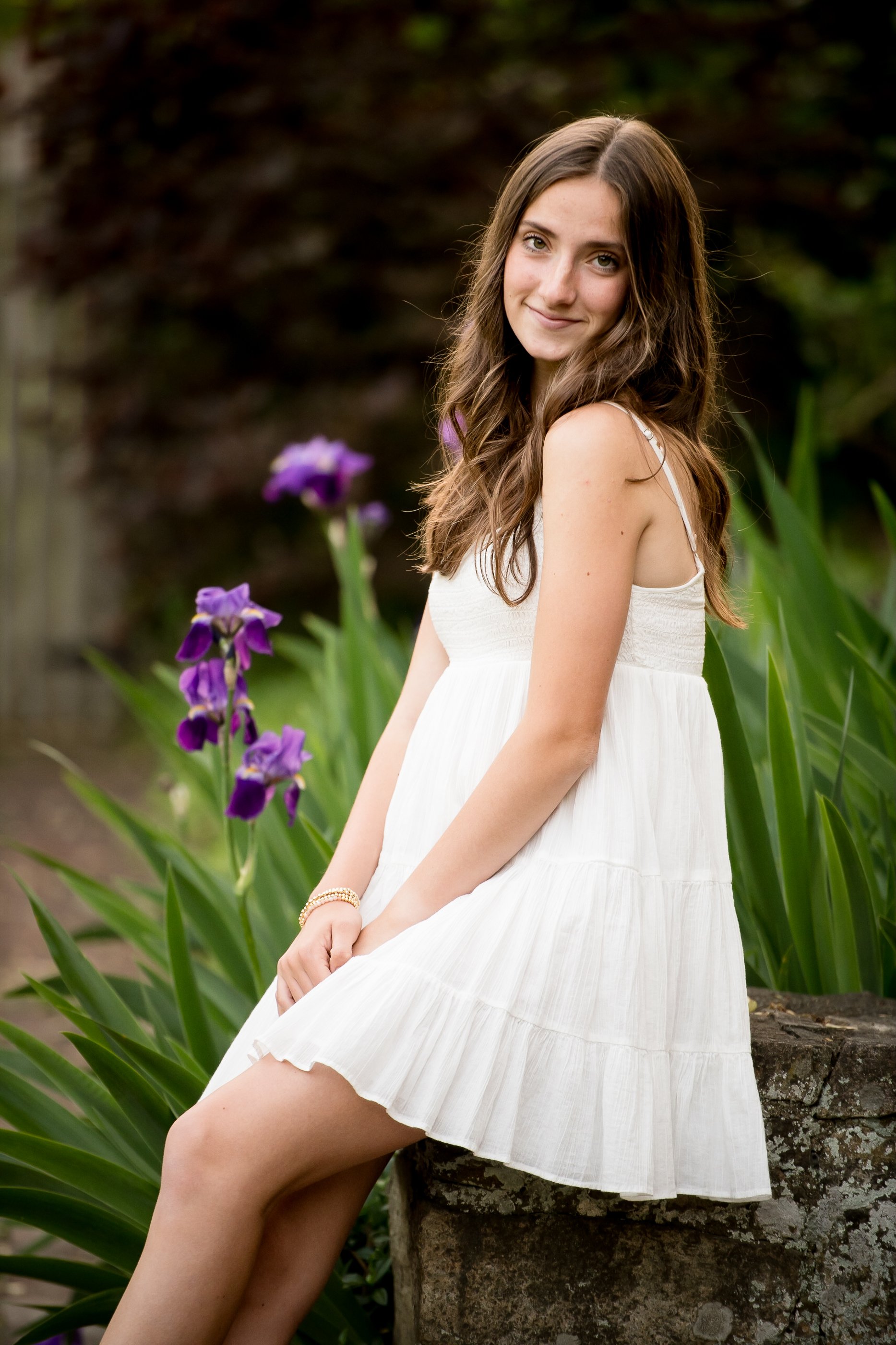  senior graduation photos walking on campus path with trees and sunlight 