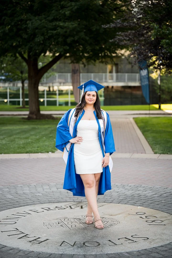  natural lifestyle portrait of senior in blue top standing in greenery 