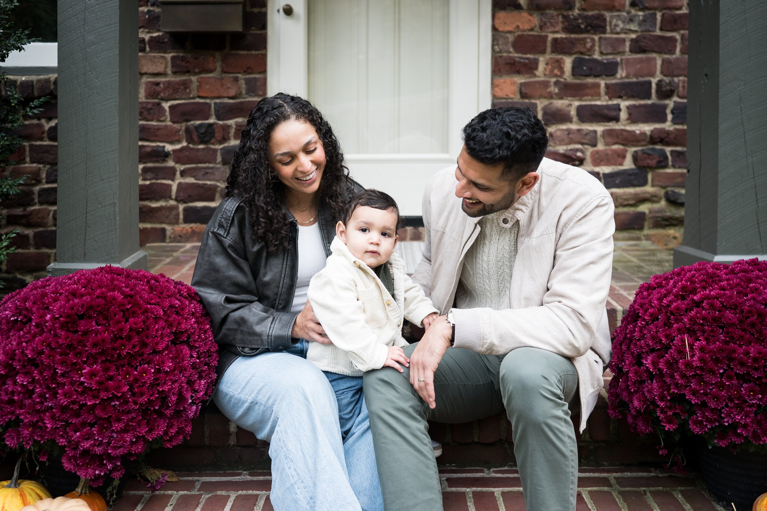 A family sitting on their front porch together, emphasizing the importance of printing family photos for albums and framed displays.