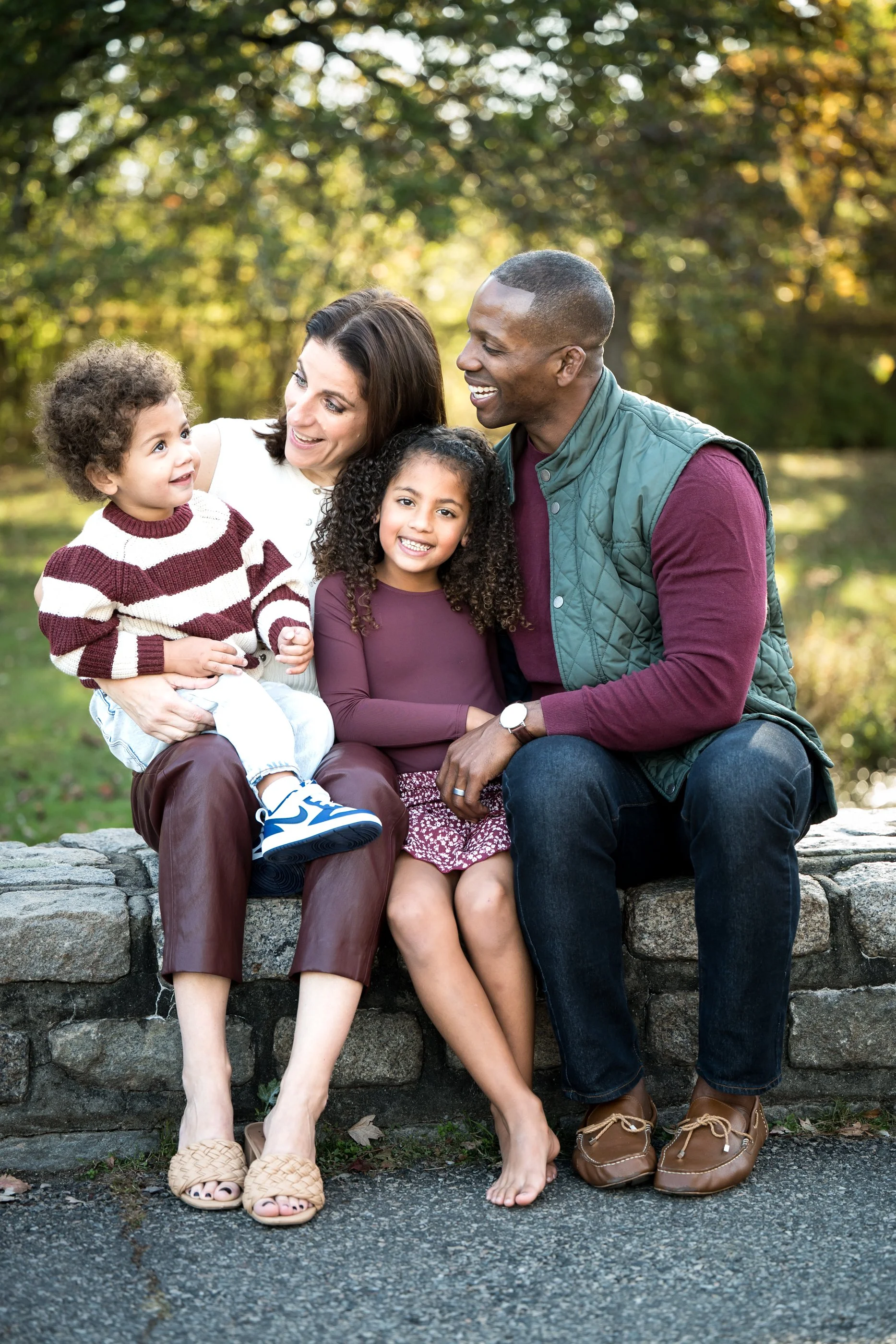 A couple smiling outdoors with their children , demonstrating how printed family photos create meaningful wall art and visual storytelling.