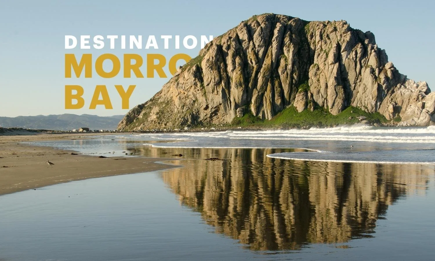 Morro Rock reflecting on the shoreline at Morro Bay, featured in an Orange County to Morro Bay three-night road trip guide.