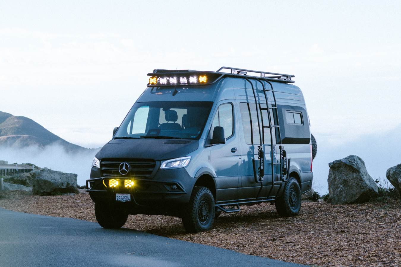 Lifted Mercedes Sprinter camper van with off-road lights at Big Sur overlook