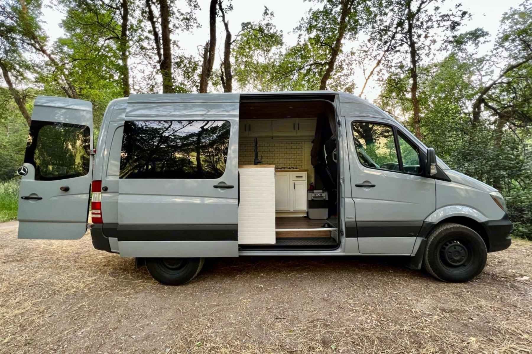 Custom Mercedes Sprinter conversion van for rent in Salt Lake City with high roof, solar power, and modern wood-and-tile interior design.