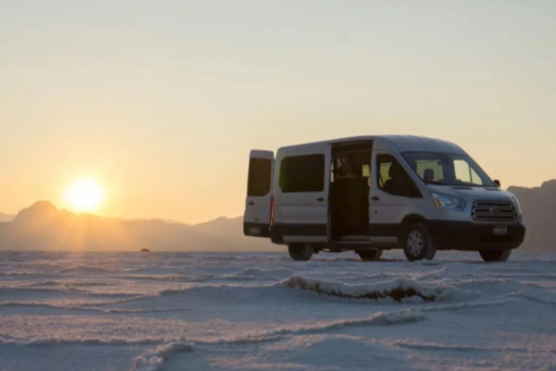 Budget sleeper van rental in Duluth, Minnesota parked outdoors at sunset, a simple conversion van ideal for affordable Minnesota road trips.