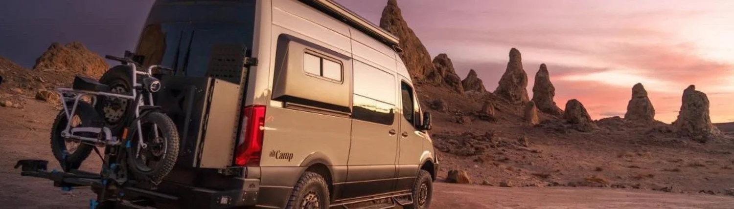 Camper van parked at sunset among the Trona Pinnacles in California
