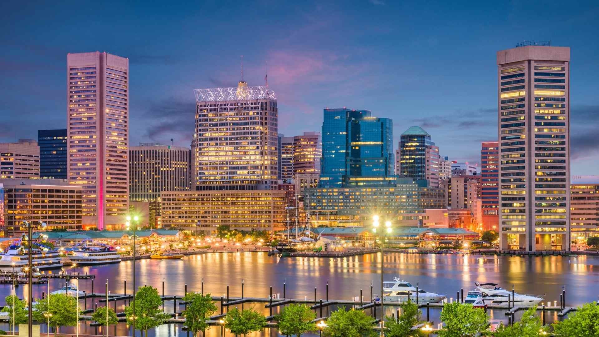 Baltimore, Maryland waterfront skyline at dusk, a popular starting point for camper van rentals and Class B RV road trips across Maryland and the Mid-Atlantic.