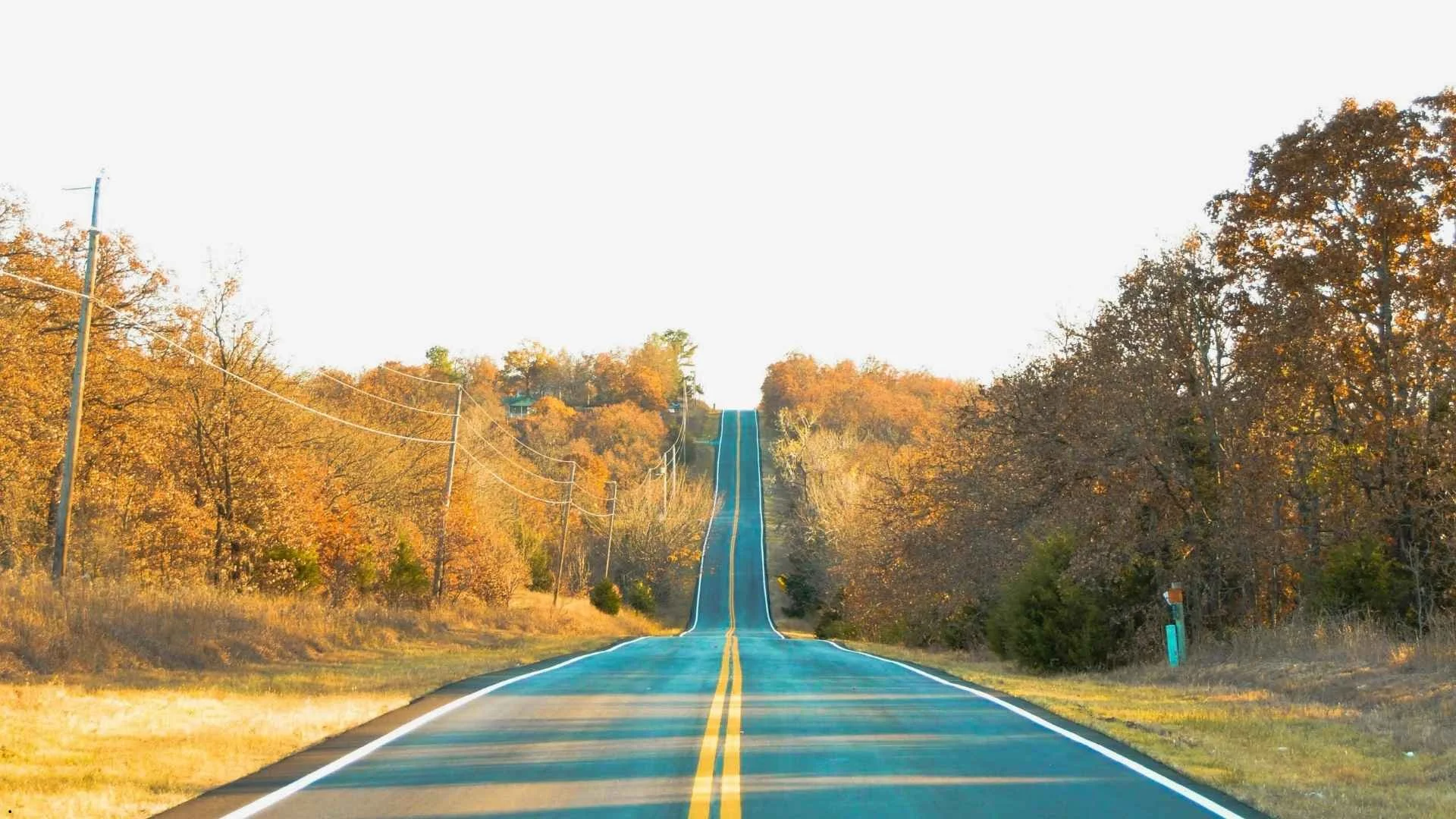 Oklahoma scenic highway lined with autumn trees, open road ideal for exploring rural landscapes