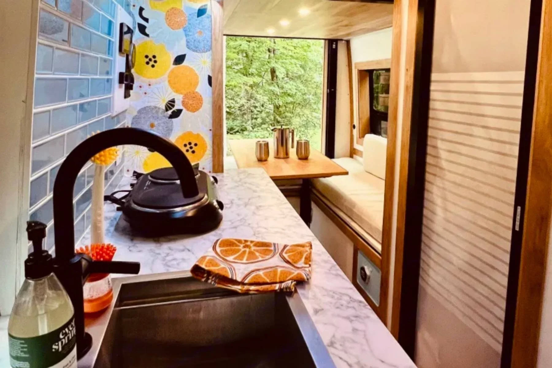 2023 Ford Transit camper van conversion rental in Oregon with kid-friendly seating and compact kitchen