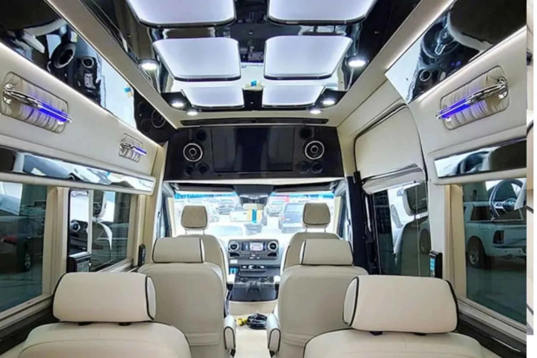 Luxury Sprinter passenger van rental interior with leather seating and LED lighting.