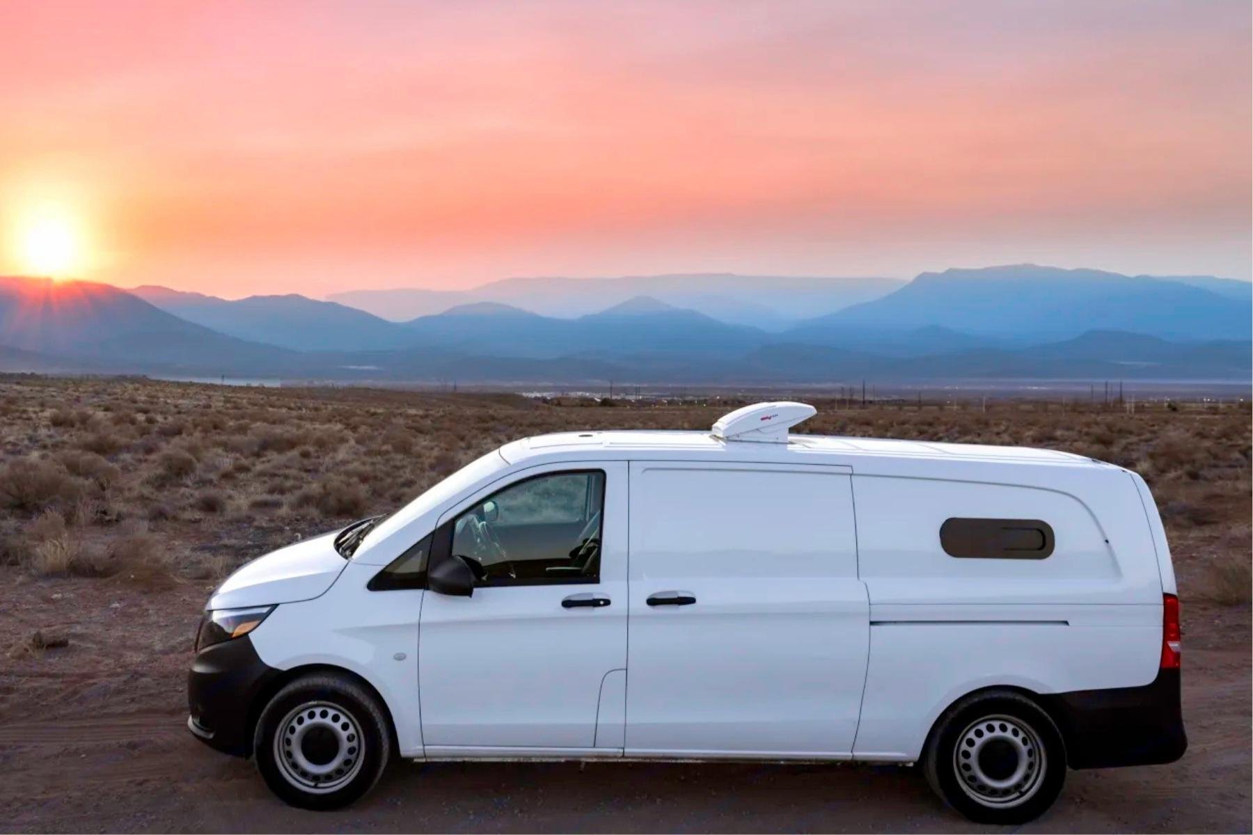 Low roof camper van conversion rental parked in the New Mexico desert at sunset