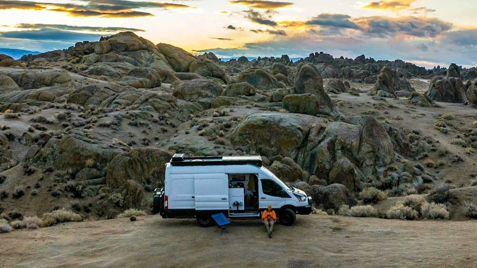 Ford Transit camper van rental parked at Alabama Hills California at sunset.