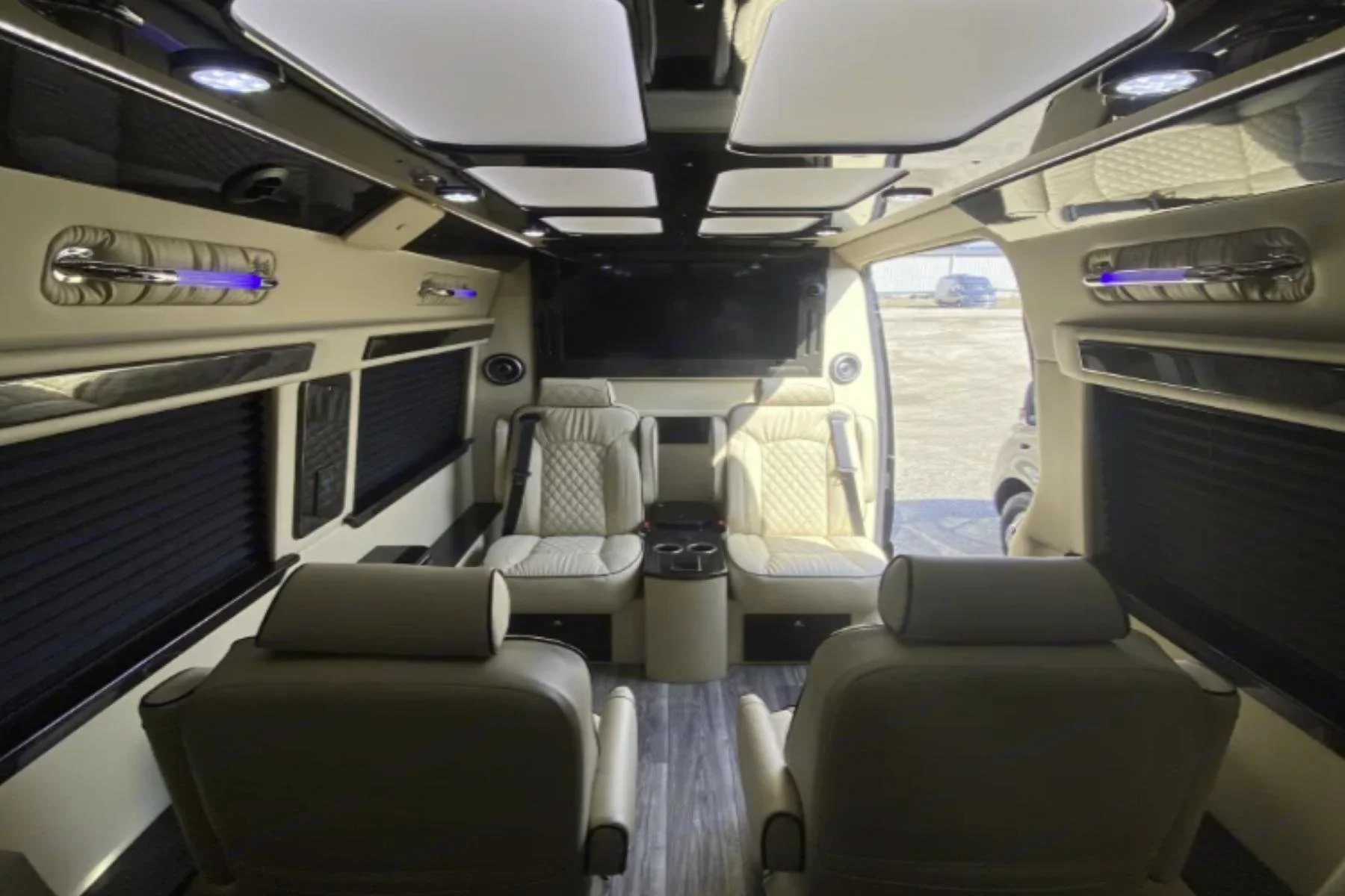 Interior view of a luxury Mercedes Sprinter passenger van in Kentucky, featuring spacious seating and a premium cabin layout.