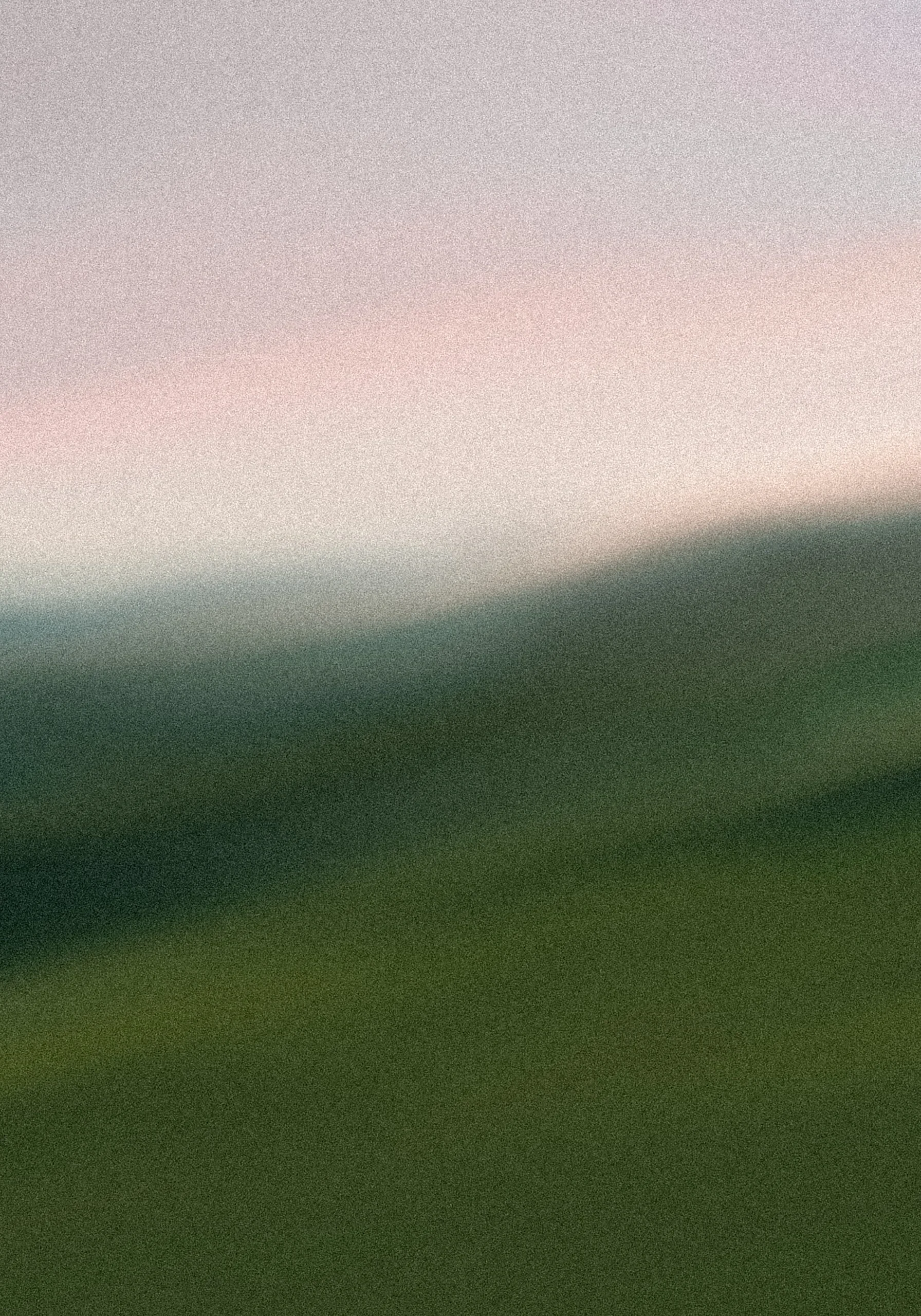 Abstract blurry landscape with green and pink hues.