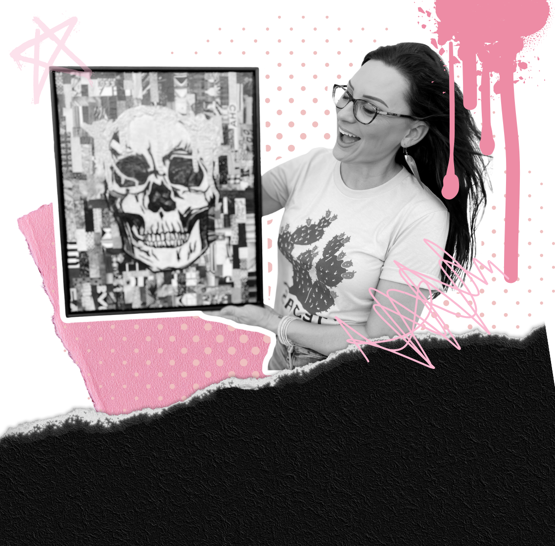 A woman with glasses and long dark hair holding a framed black and white art piece of a skull with a rat on top, smiling and looking excited.