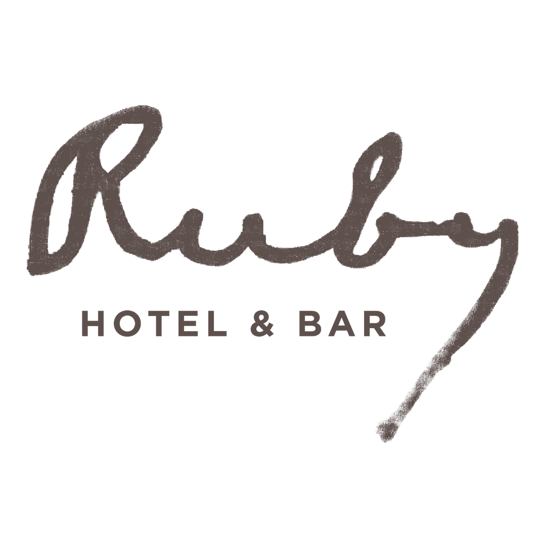 Logo for Ruby Hotel & Bar, featuring the word "Ruby" in cursive above "Hotel & Bar" in bold lettering.