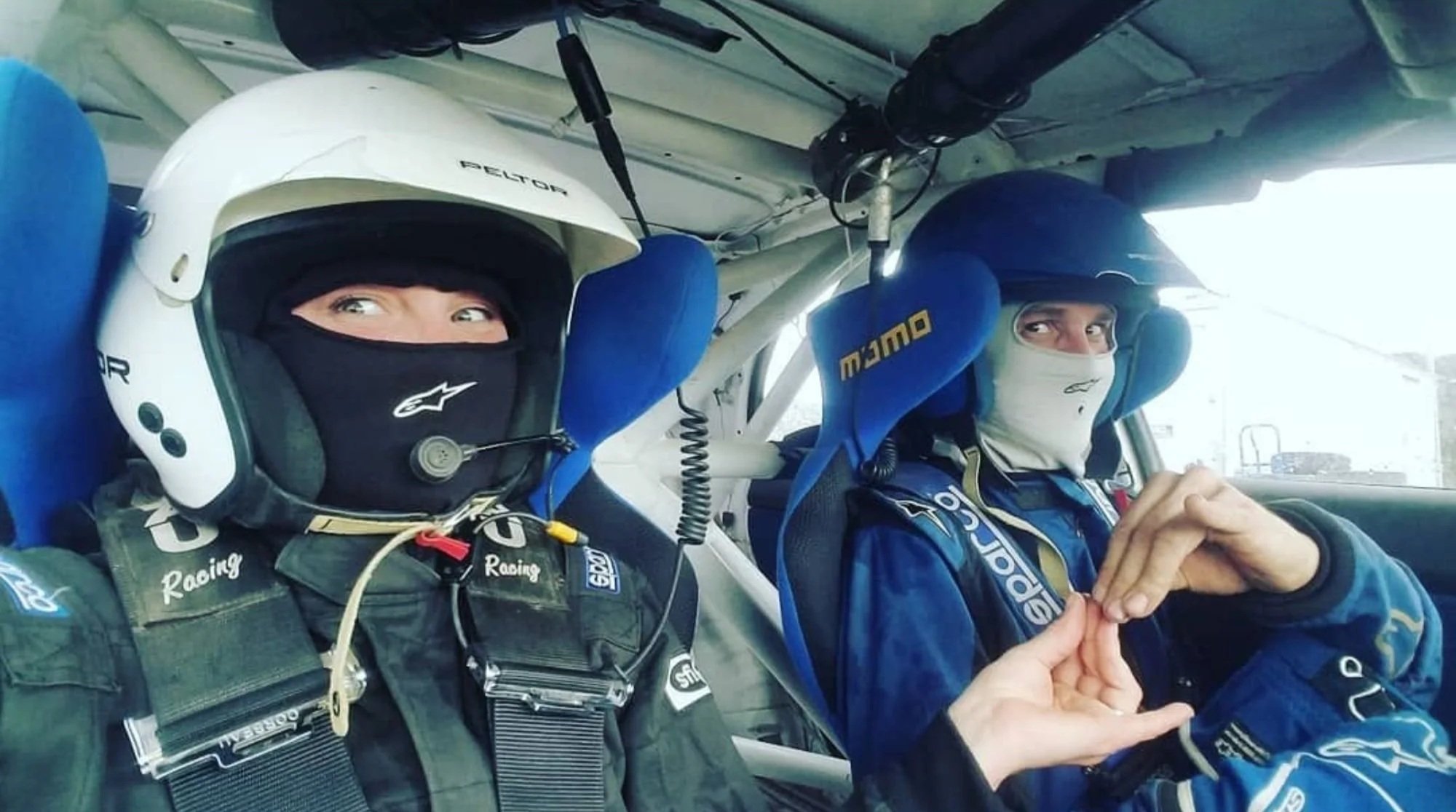 Andy and Katie in the cockpit of a race car