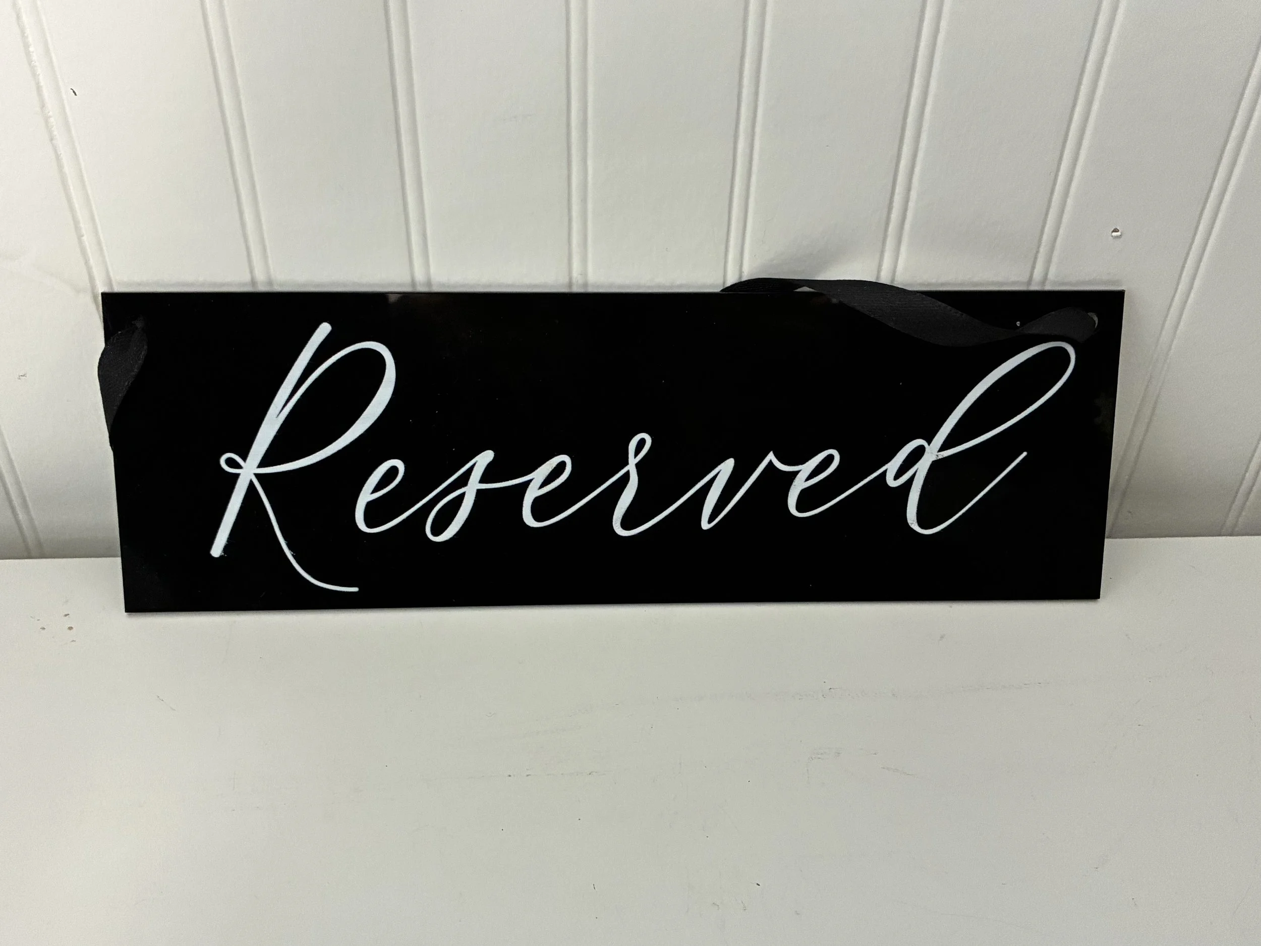 Black Acrylic Reserved Sign with White Lettering.jpeg