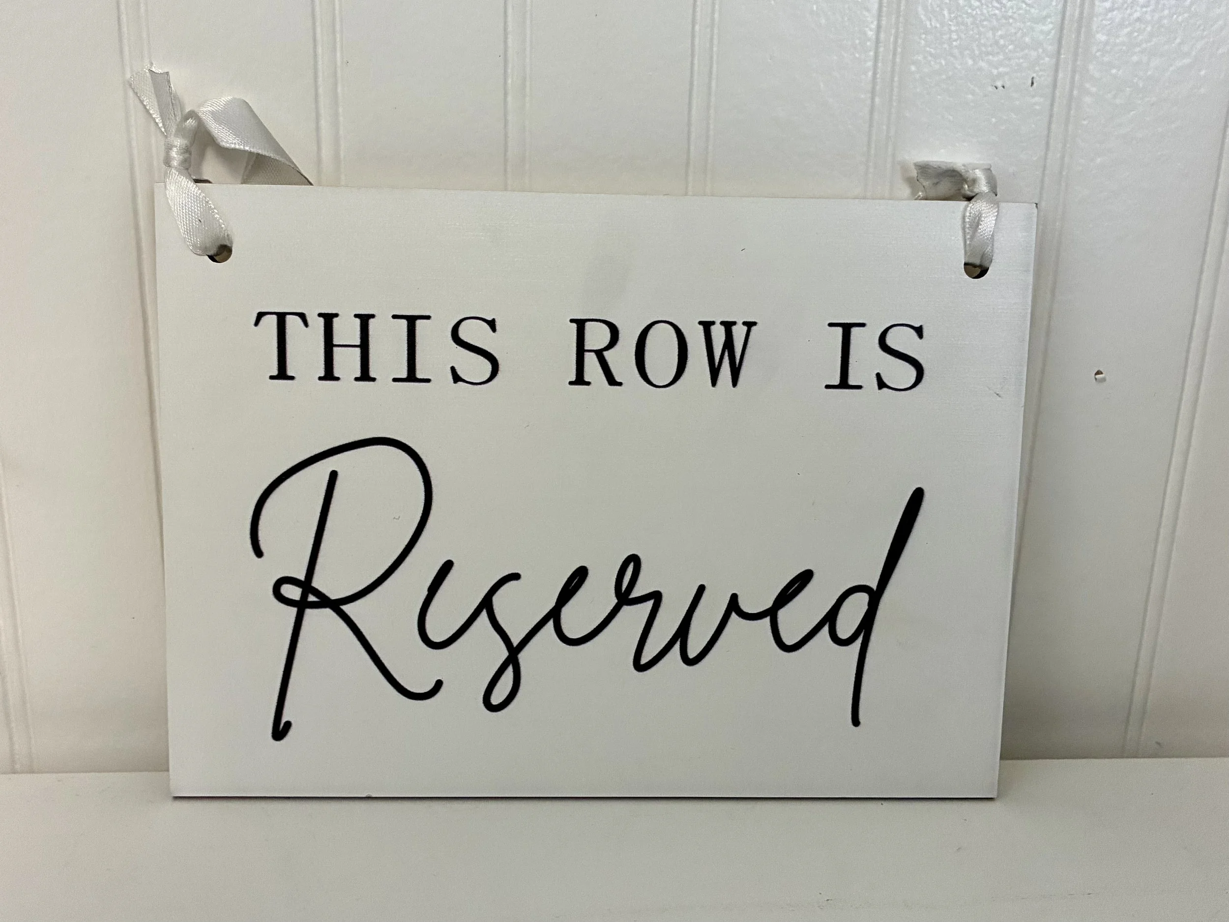 White Wood Reserved Sign with Black Lettering.jpeg