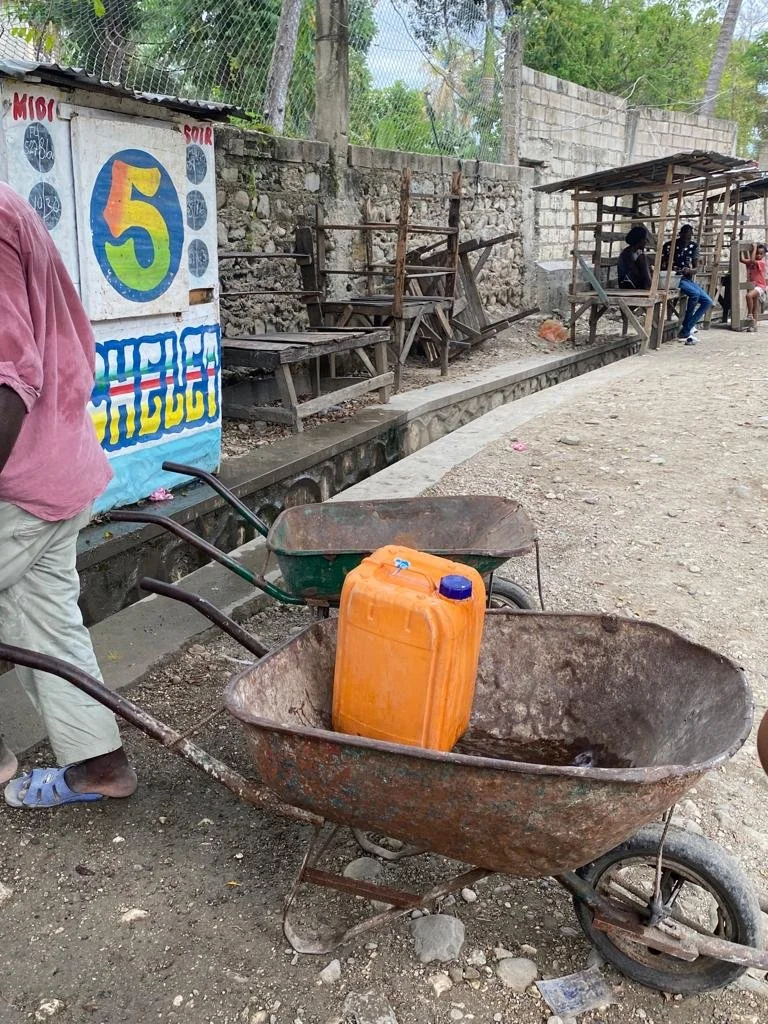 The jugs are transported via wheel barrow